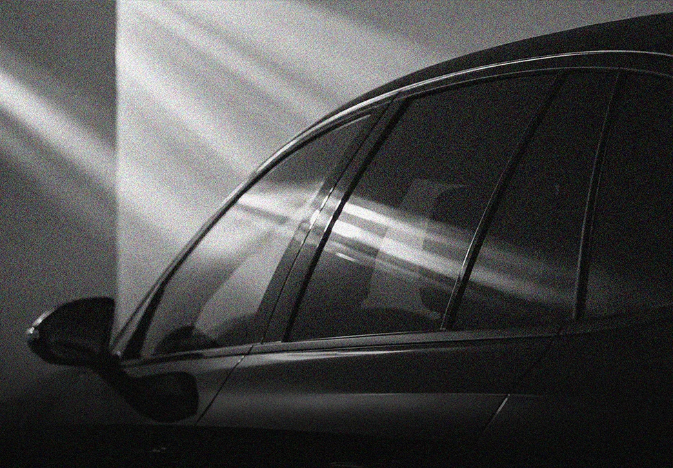 Automotive side glass with a dark window-film finish
